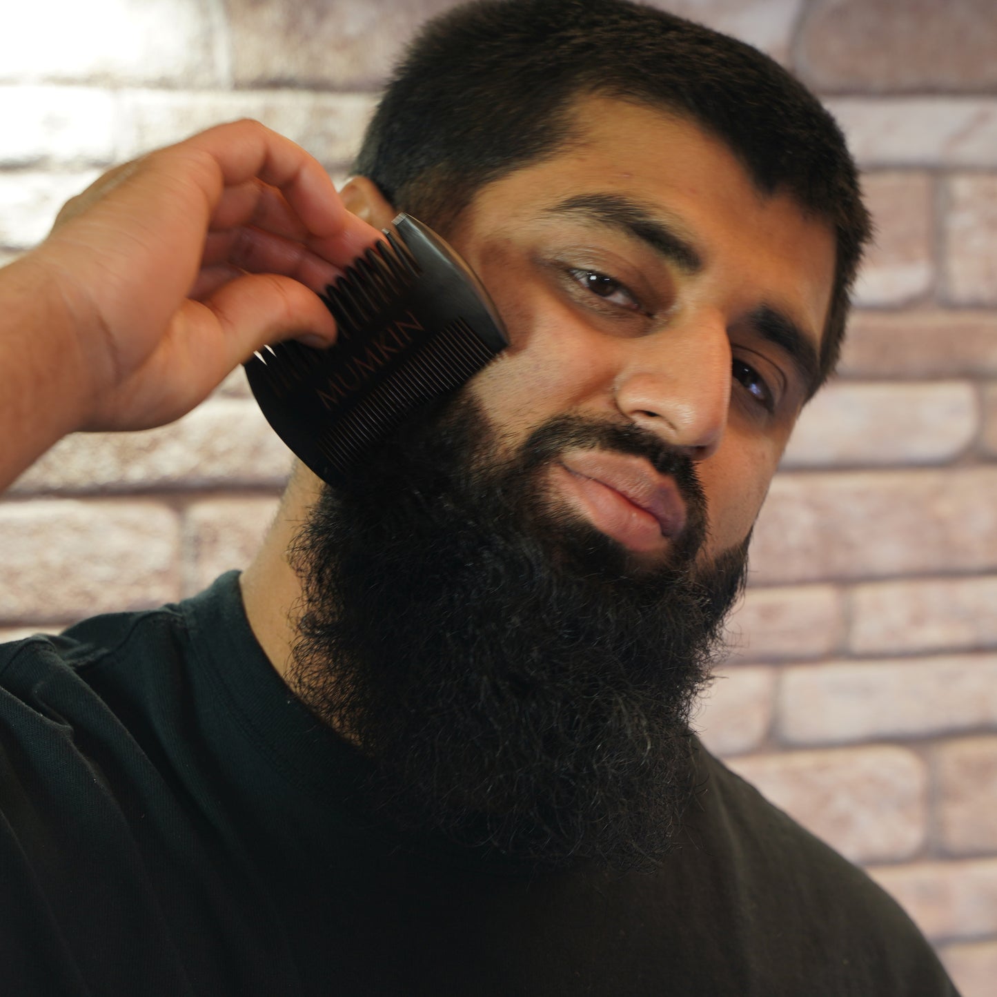  A smart Man Using Beard Comb 